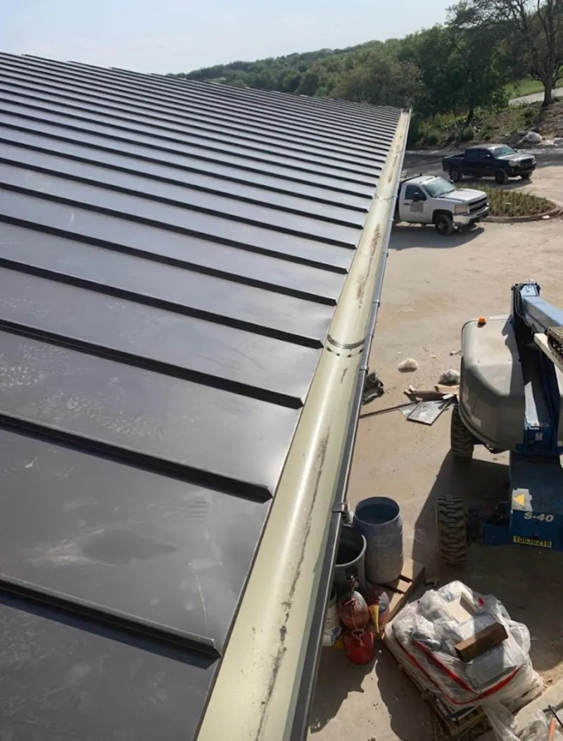 Standing seam panel and gutter detail on a metal roofing jobsite in Fircrest